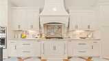 Kitchen with Custom Hood and Backsplash