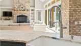 Kitchen Featuring Kohler Pulldown Faucet and Farmhouse Sink