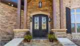 Vaulted Columned Front Porch with Double Door Entryway