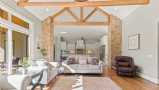 Great Room with Natural Wood Beams & Brick Columns